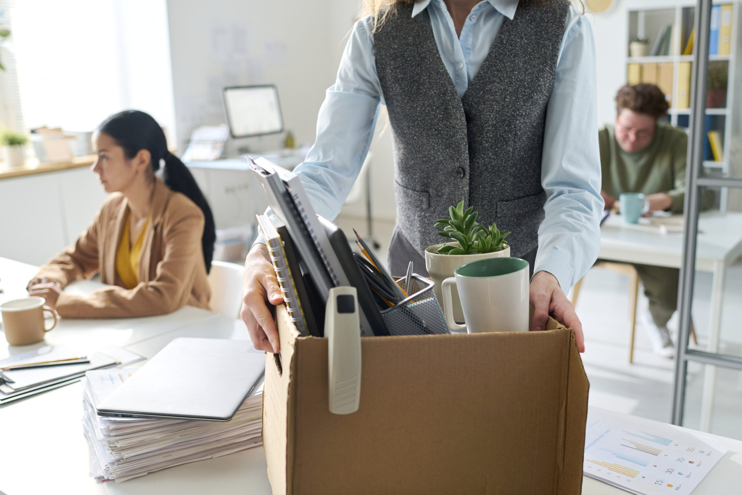 Employee packing box with personal items after submitting resignation